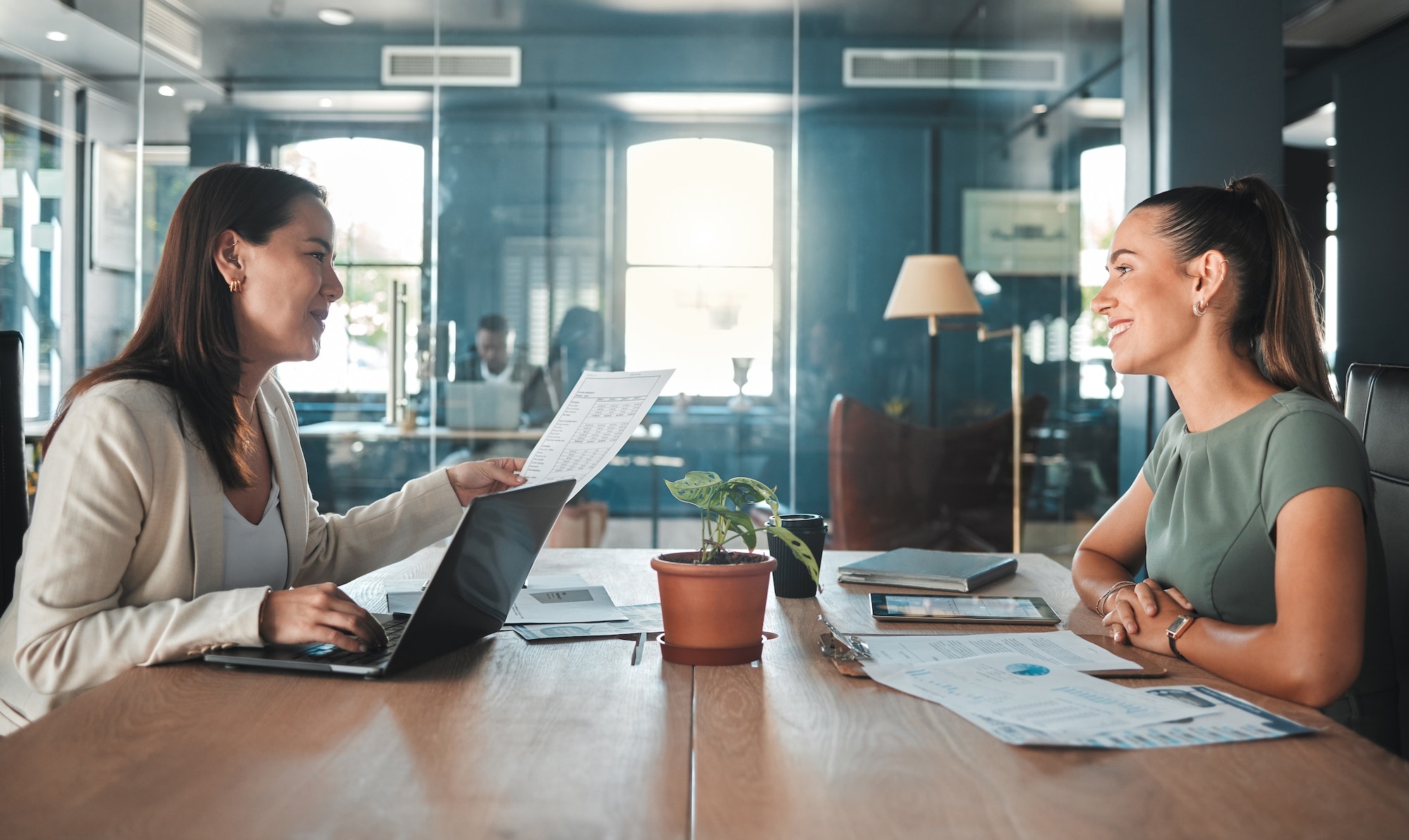 Job interview for a business woman at a hiring company talking to the HR manager about the role or